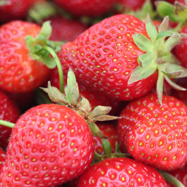 Group of ripe strawberries up close